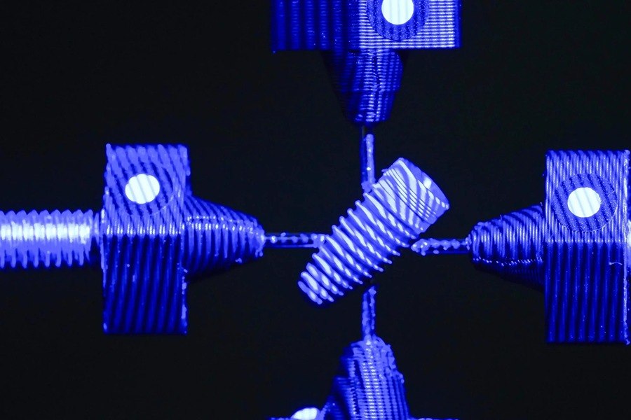 Close-up of a blue structured-light fringe pattern projected across a threaded part