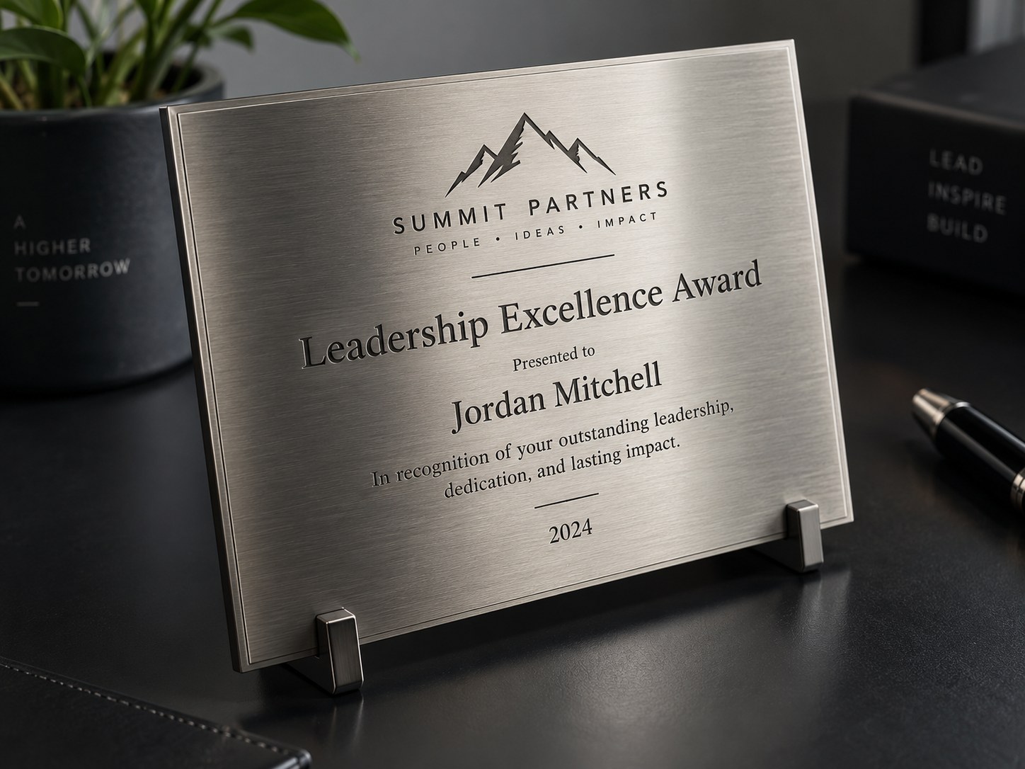 A brushed stainless recognition plaque engraved with an award title, a recipient name and the year