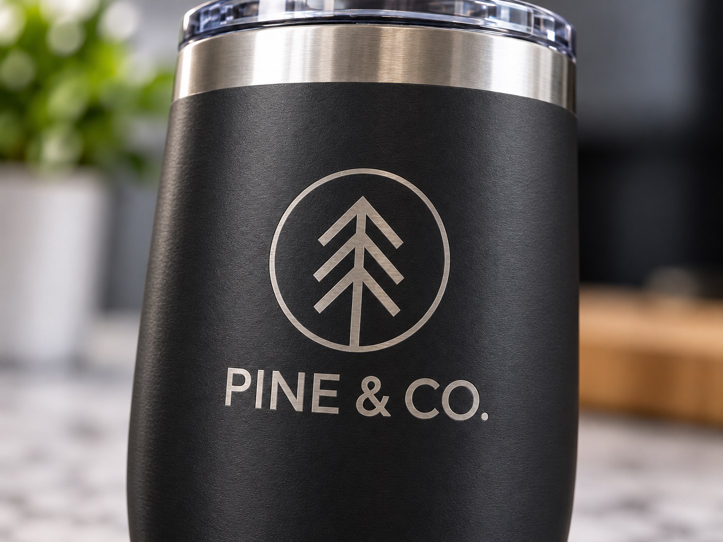 A café counter with an xTool F2 Ultra engraving machine, a custom engraving sign and finished personalised tumblers
