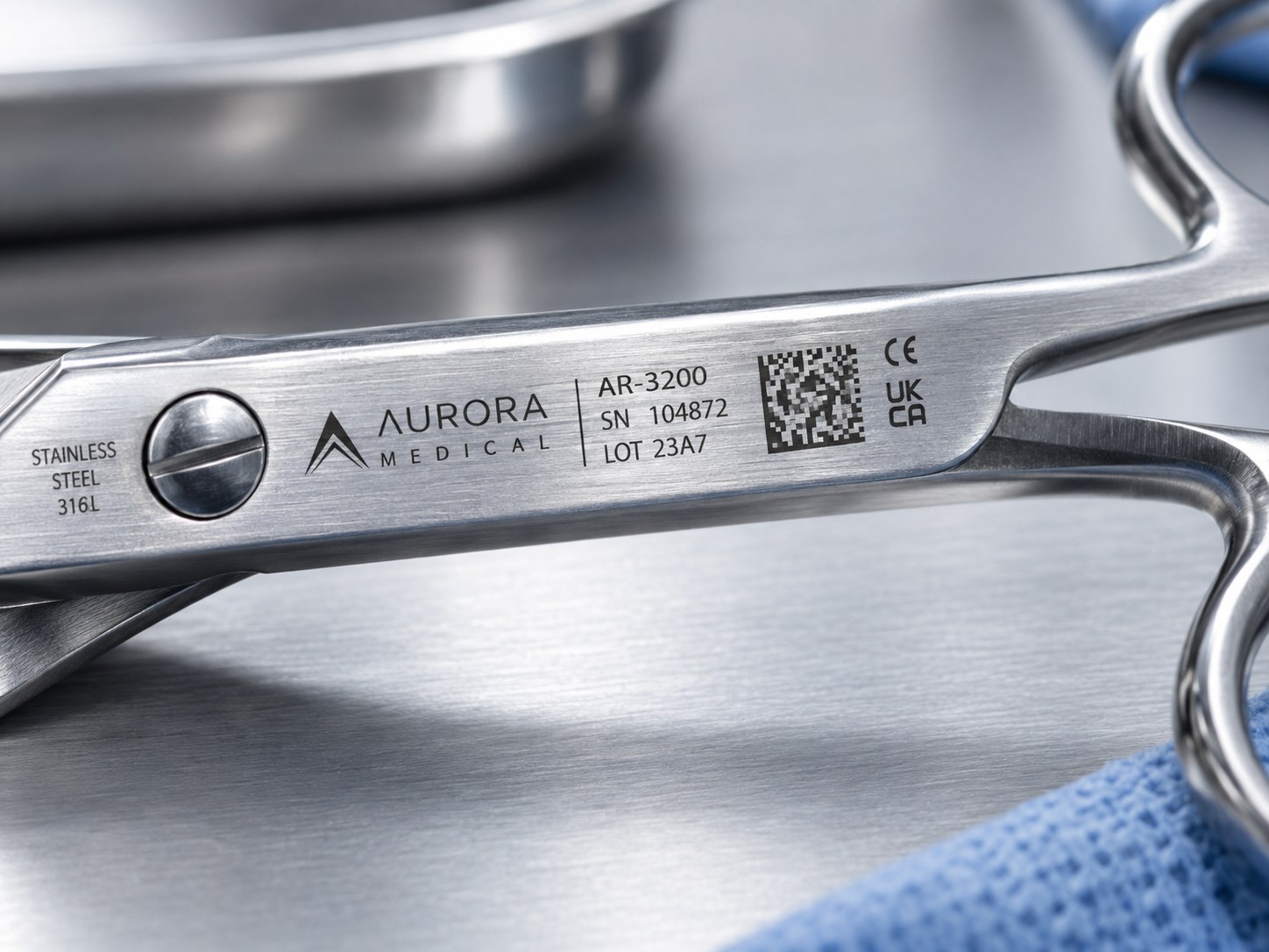 Close-up of a laser-marked stainless surgical instrument showing its serial number, lot code and data matrix mark