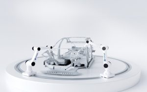 Collaborative robot cell with multiple arms around a car frame — the robot is one component of the system
