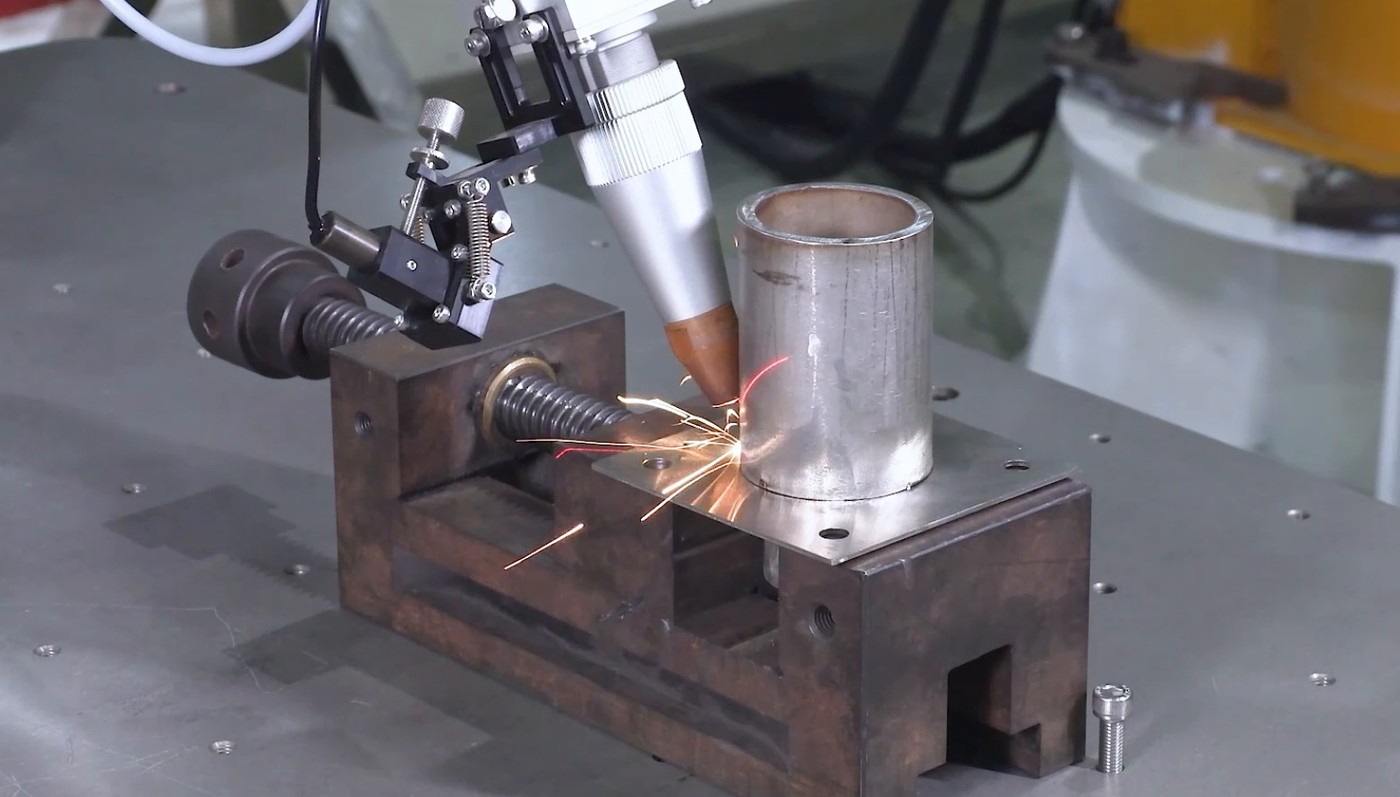 Cobot laser welding a steel tube on a fixture