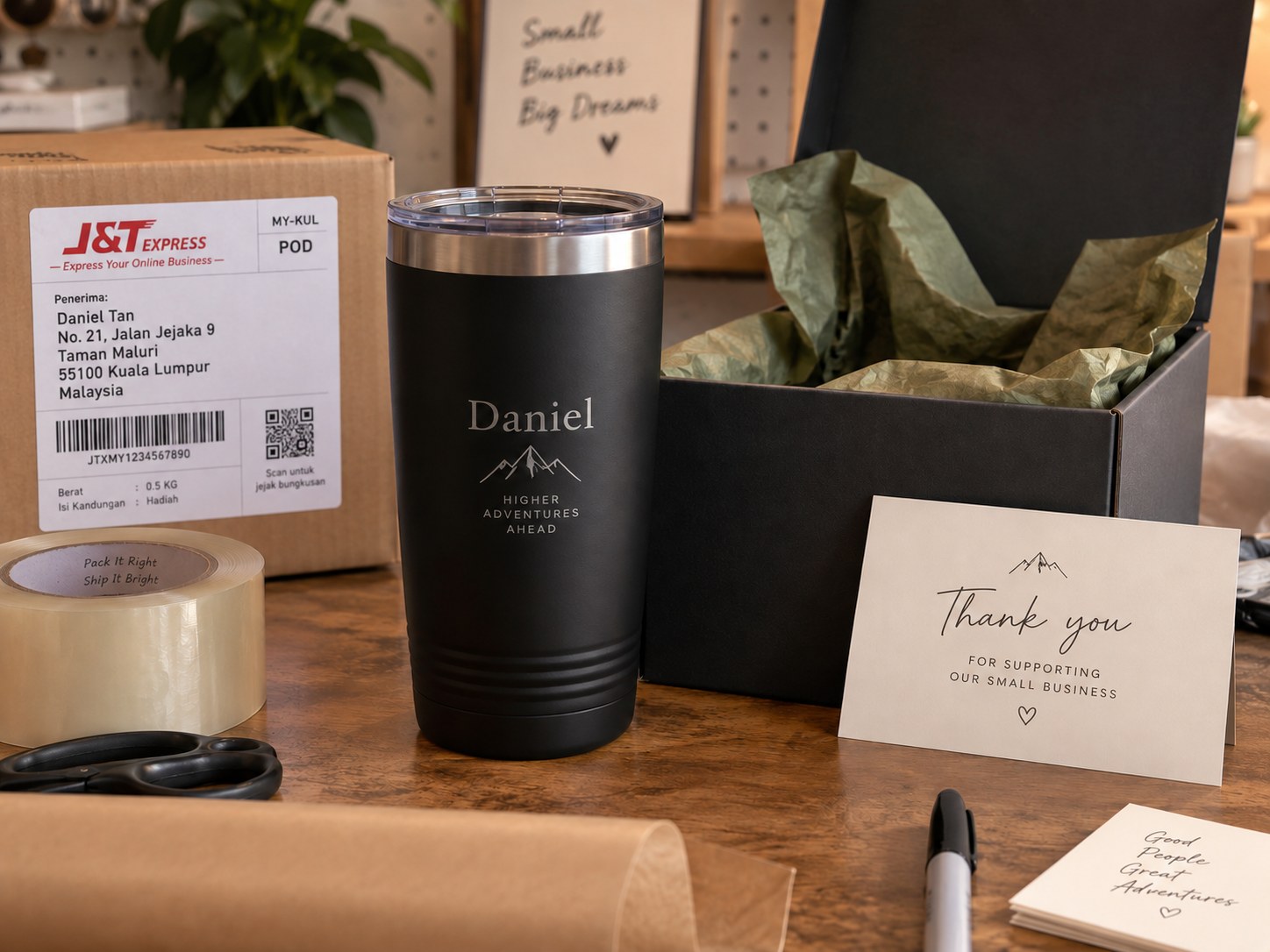 A personalised tumbler engraved with a name and a mountain mark, packed in a gift box with tissue paper and a card
