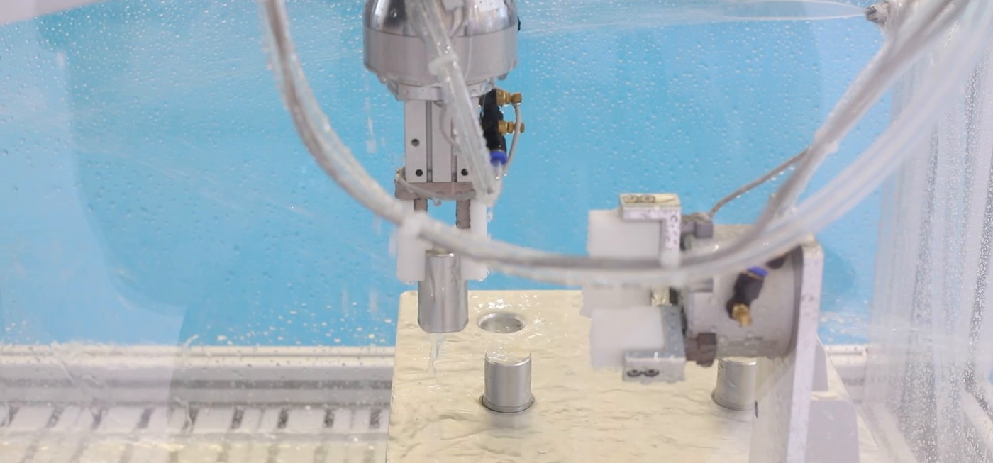 Pick and place robot gripper inserting a metal bushing into a plate