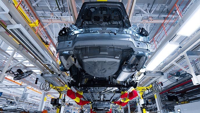 Car bodies on an overhead conveyor at an automotive welding line